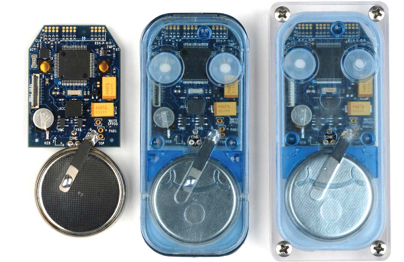 Posture and activity detector 1 (PAD1) printed circuit board assembly shown next to two different styles of PAD1 case assemblies